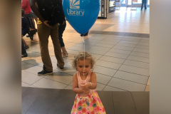 Ava holding a balloon at the library's grand opening