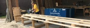 Woman performing General Labor building pallets