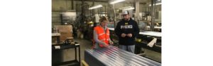 Production Workers placing labels on panels