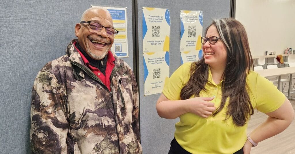 Photo of Larry and Seija laughing together at work