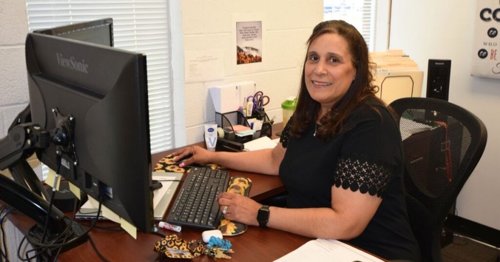 Diane sitting at her desk