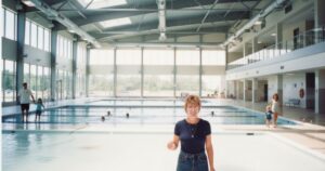 aquatics director posing in front of indoor pool