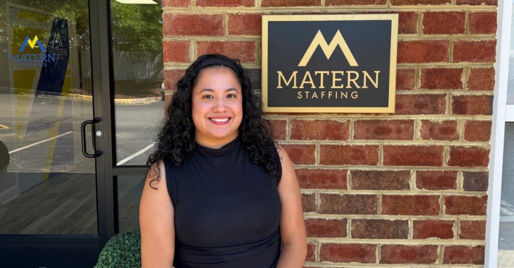 Maria standing outside near the Matern STaffing logo