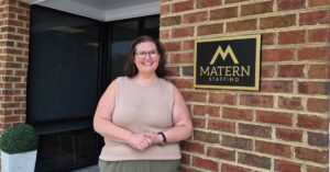 Glenda standing by the Matern sign.