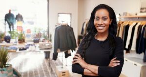 retail person standing in front of merchandise at nonprofit organization