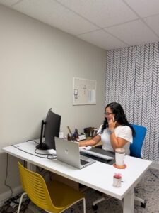 Maria at her desk on the phone