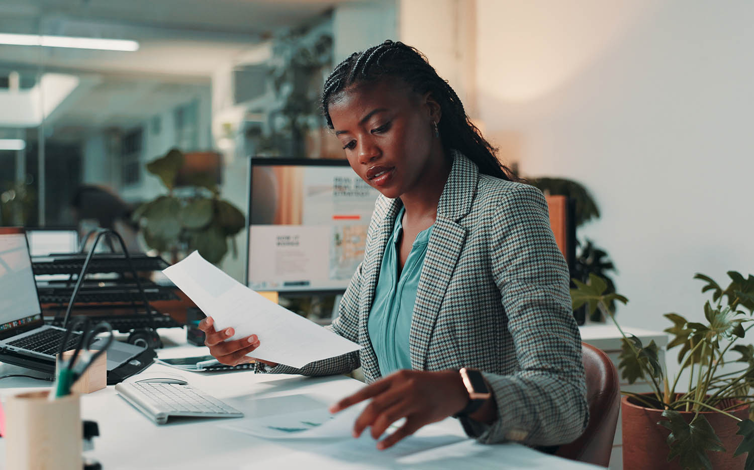 Woman reading by computer in office for project Woman reading by computer in office for project