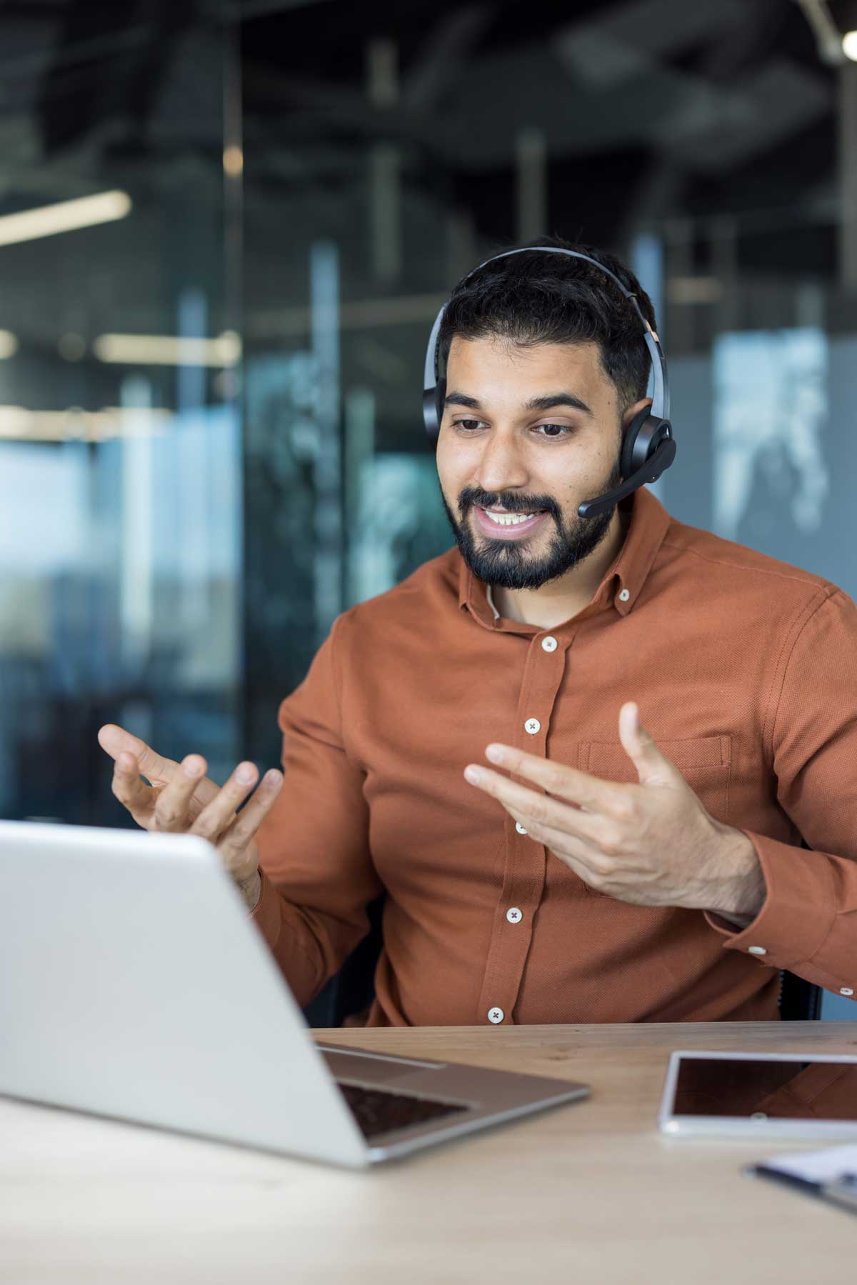 AdobeStock_1715005992 A businessman in blue shirt is holding object in his hand, is searching for personnel or people